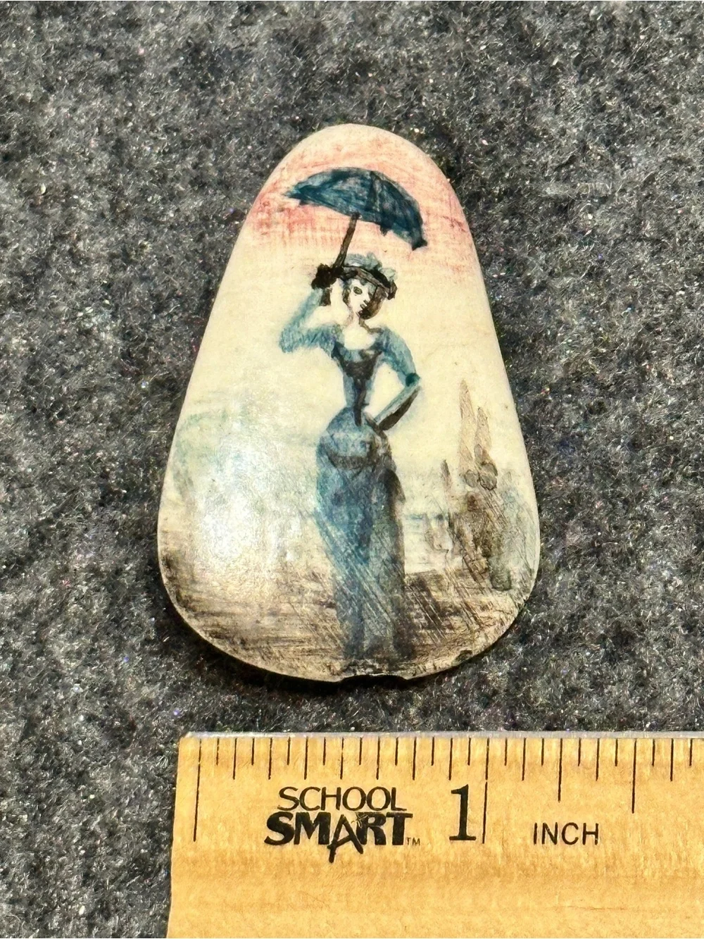 Small, hand-painted miniature artwork on a smooth stone or ceramic cabochon